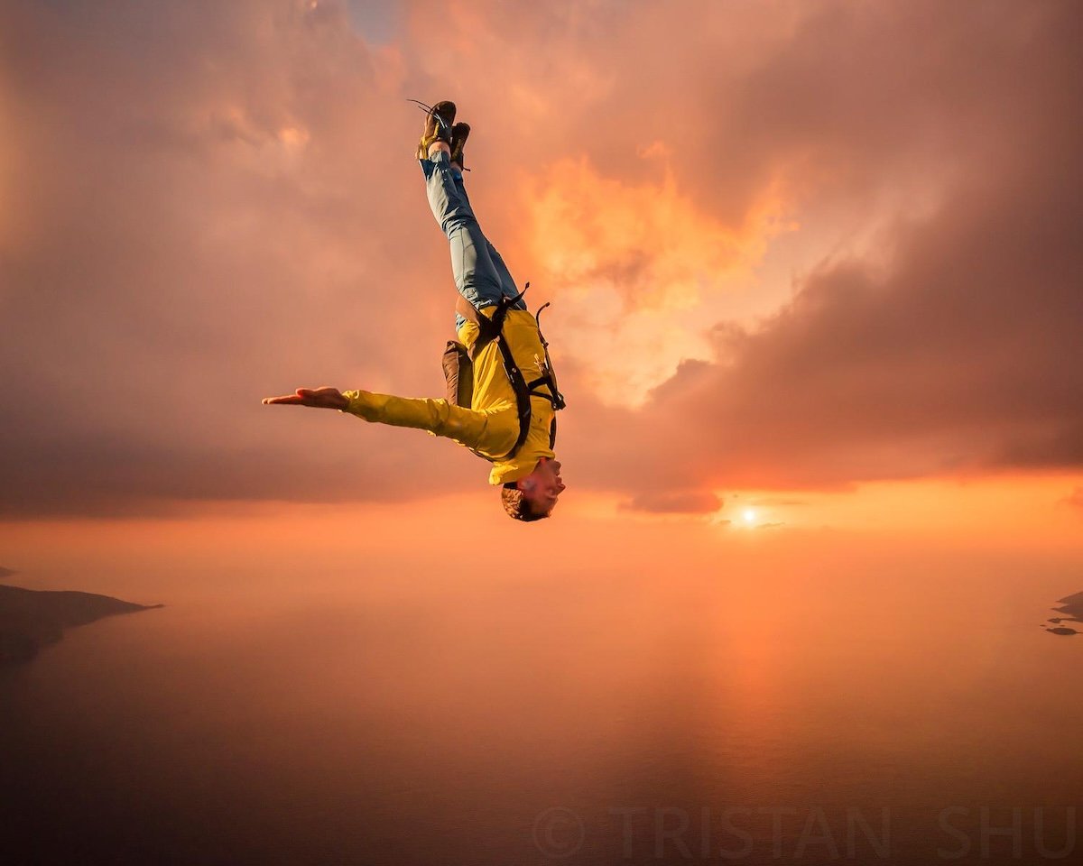 A skydiver falling in the air at sunset taken by one of the best sports photographers Tristan Shu
