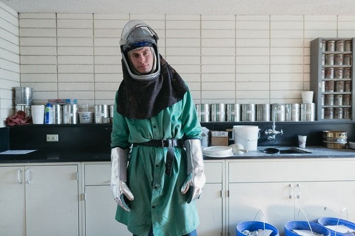 photographer wearing safety gear to handle harmful chemicals