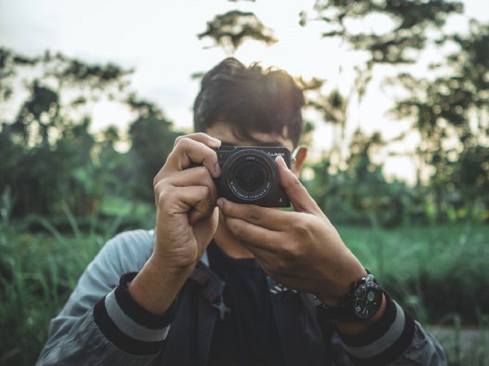 photographer holding a compact camera