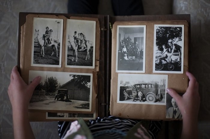 child looking at a black and white photo album