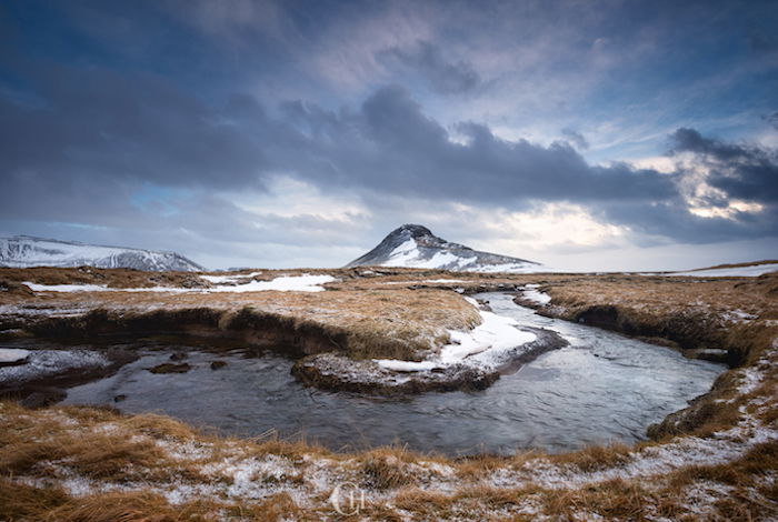 slow moving river flowing through a winter landscape