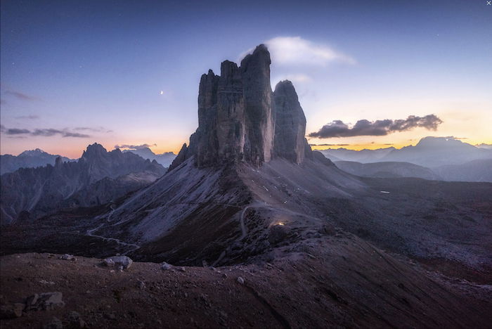 landscape photography inspiration: tall rock face in front of a sunrise