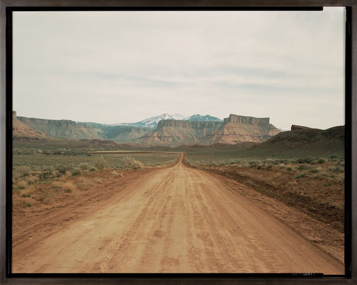 desert landscape: a lonely dirt road leading to a rocky ridge