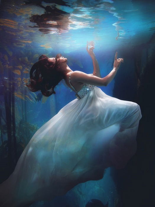 woman in a white dress floating underwater