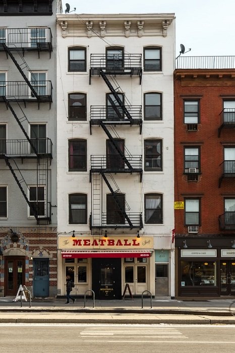 fire escape above a meatball shop in an urban setting