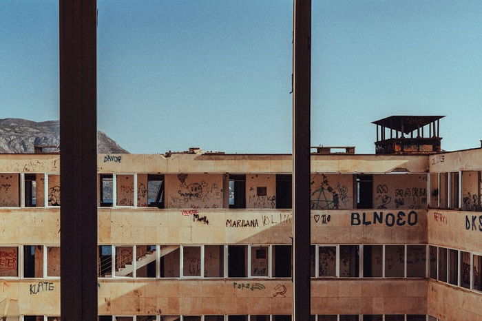 looking through the window into the courtyard of a building in ruins