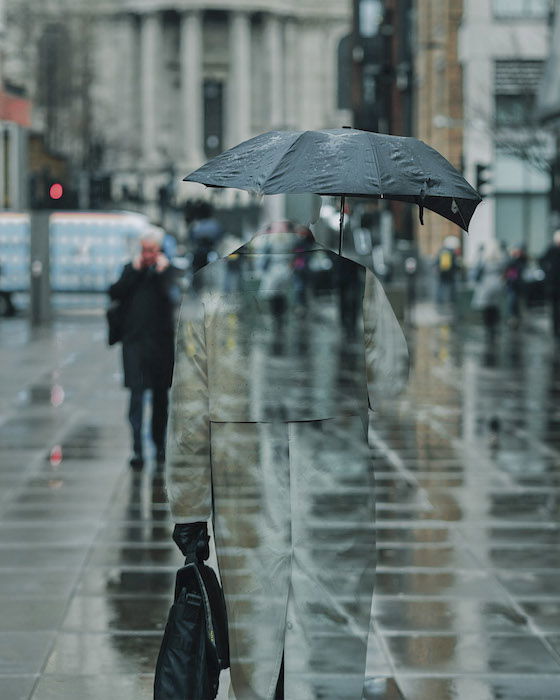 a double exposure effect of a transparent man blending into a street scene as a creative Photoshop idea