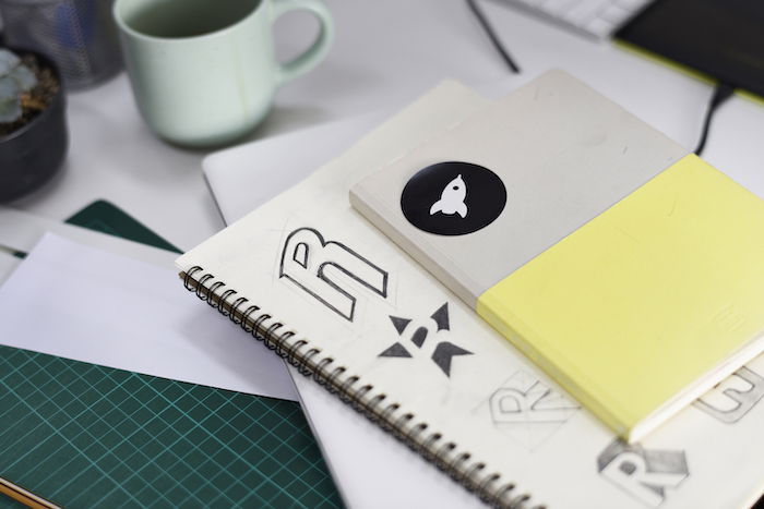 A notebook with brand logo ideas