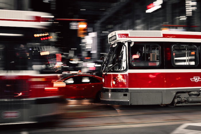 Two blurred fast moving trains about to pass each other at night