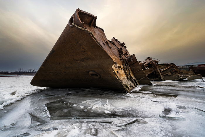 Rusted shipwreck on icy water with AI sky replaced using Adobe Photoshop