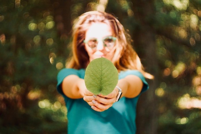 AI Photography: An image with a shallow depth of a woman holding a leaf