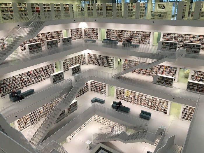 best stock photo sites: a multi-floor library with a chic white colour scheme