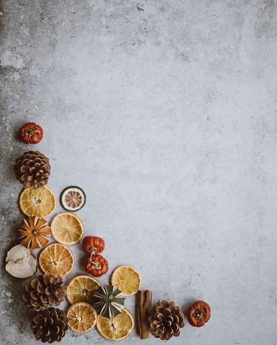 Christmas flat lay of dried fruit and pine cones on an icy backdrop