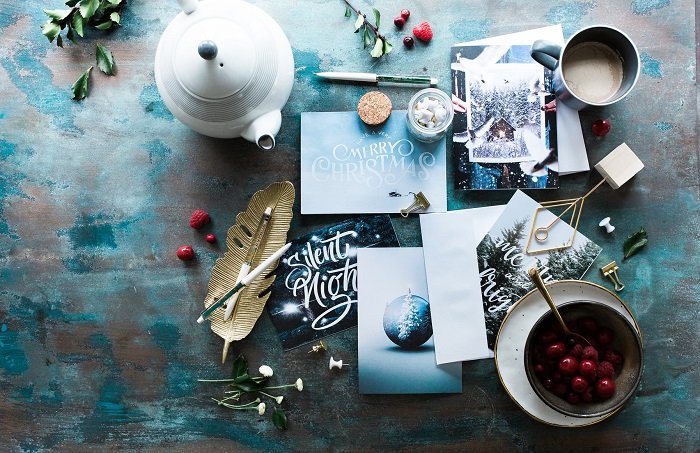 Christmas flat lay of stationary cards dishes tea and fruit