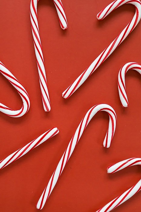 Christmas flat lay of candy canes on a red background