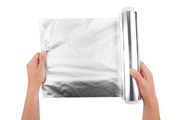 diy light reflector: tinfoil held by woman