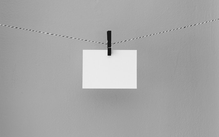 diy light reflector: A white card hanging on a clothesline by a clothespin