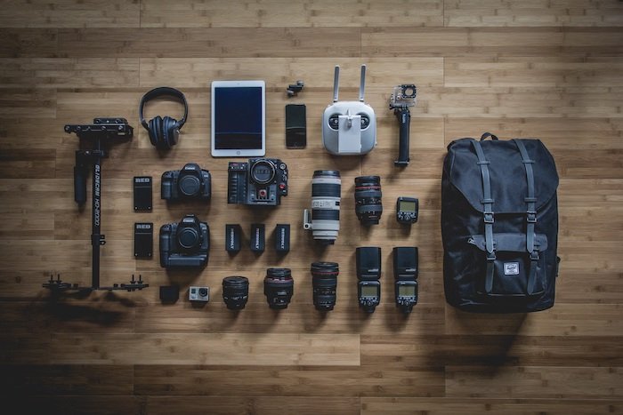 Flat lay photography: Bird's eye view of photography gear laid out neatly on wood floor panels