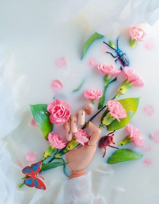 floral flat lay: a prosthetic hand and toy insects used to create a more lively image