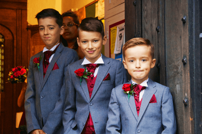 wedding shot idea: Pageboys ready to receive guests at the church
