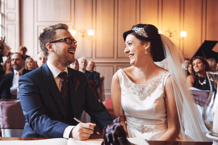 wedding shot: a newlywed couple signing the register