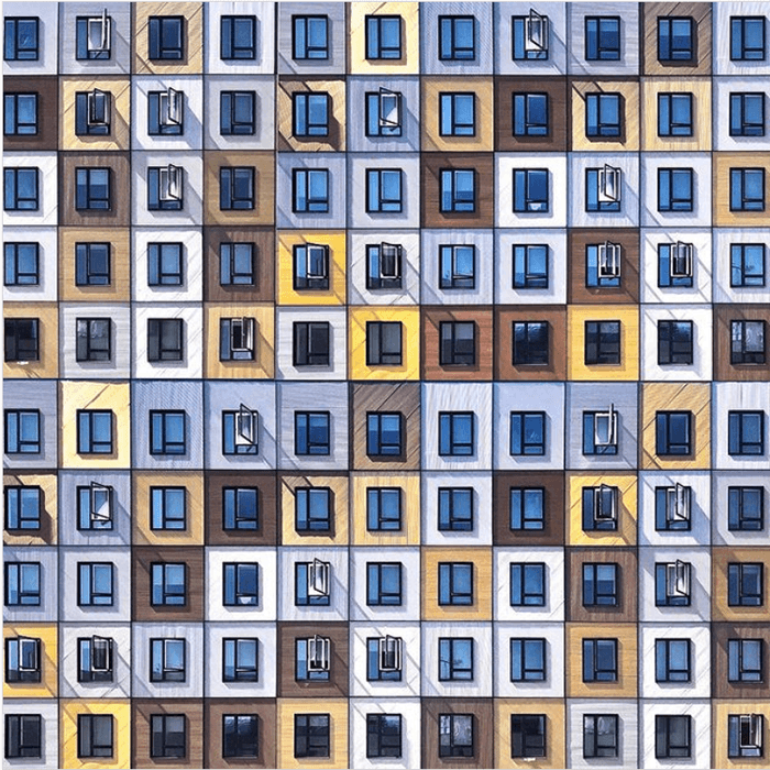 colourful windows of a building make a grid photographic pattern