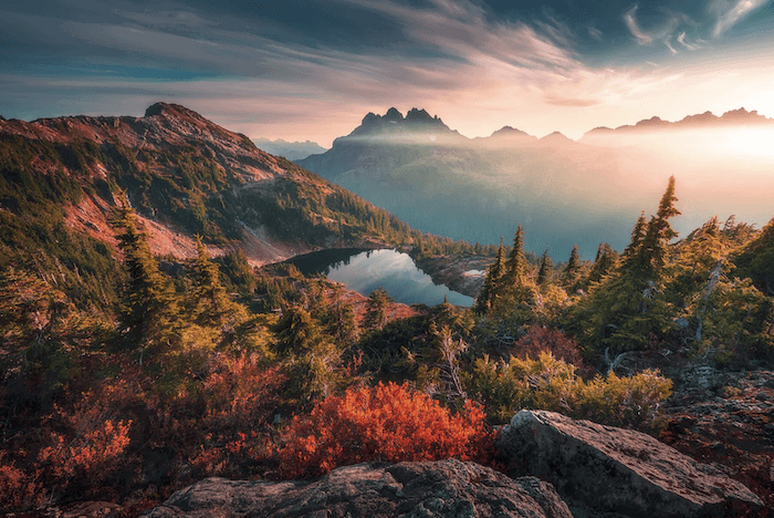 landscape during sunrise with a lake at the center of the frame 