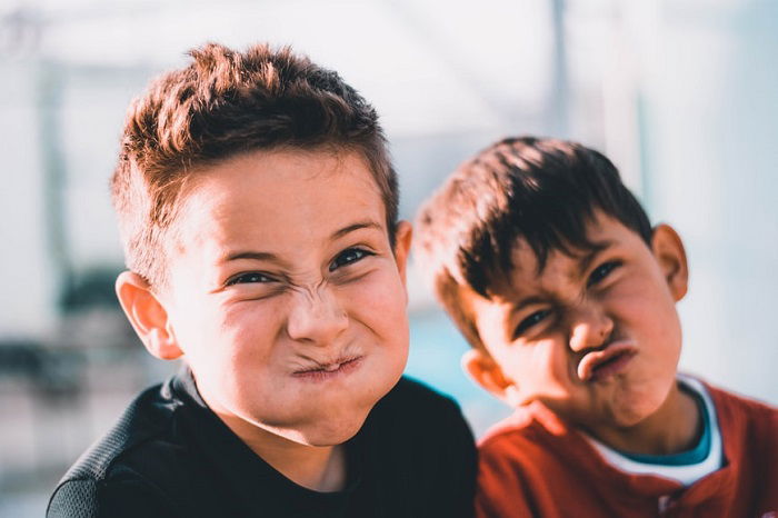 photo ideas for siblings: siblings pulling silly faces