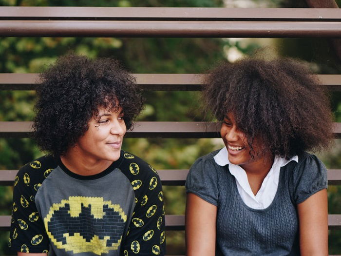 photo ideas for siblings: candid pose of siblings in conversation