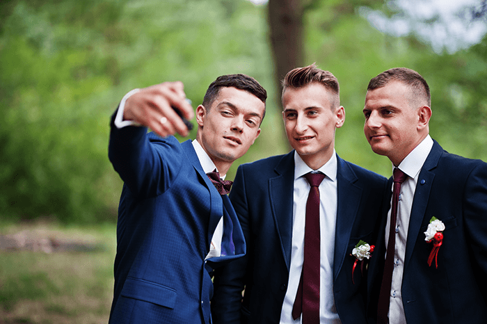 The groom and groomsmen taking a selfie