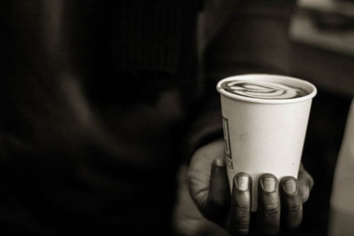 shape in photography: placing the coffee cup in the palm of a hand to create a suspenseful mood from its shape