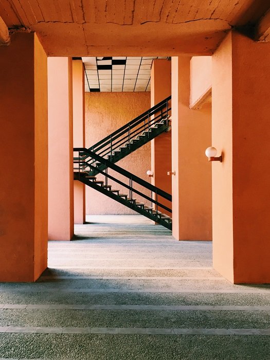 Staircase photography idea: black staircase with bright orange walls