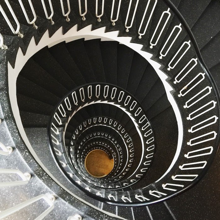 Repetition of patterns in a spiraling staircase photographed from above