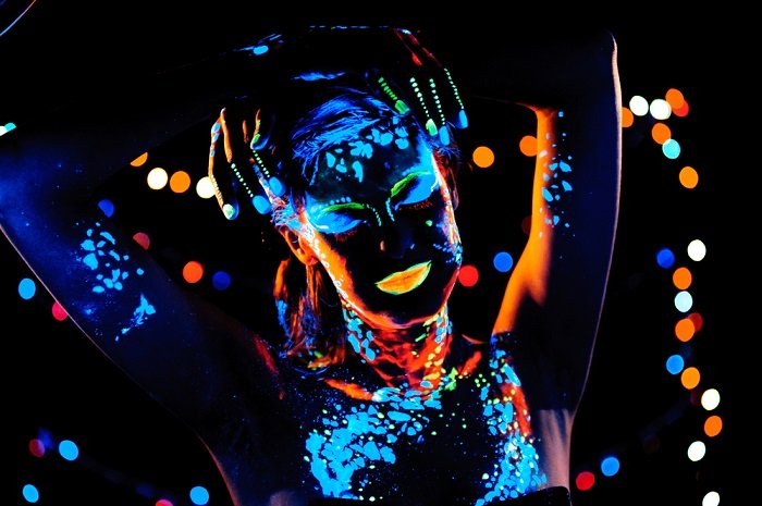 black light photography tips: a woman in ultraviolet paint is a vibrant example of portrait black light photography
