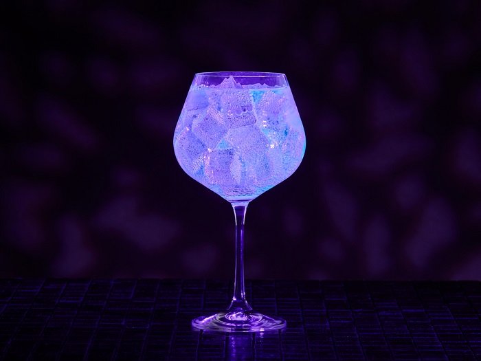 black light photography ideas: an example of food and drink photography shot of an illuminated gin and tonic