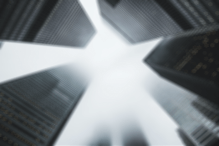 A Shape blur effect in Photoshop applied to an image of buildings rising into the sky