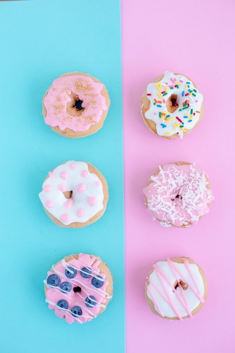 color block photoshoot ideas: 6 donuts in a flat lay photograph with blue and pink pastel background