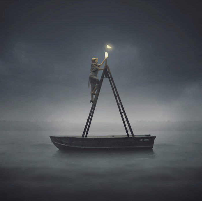 Composite photography image of a person climbing a ladder in a rowboat trying to catch a lit butterfly