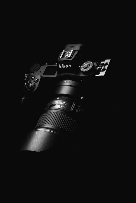 Nikon DSLR camera and lens on a black background