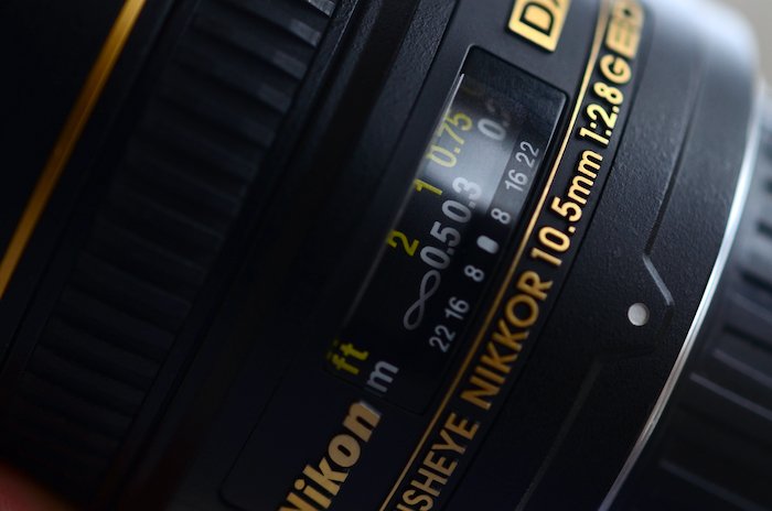 a close up shot of a Nikon lens and its listed abbreviations