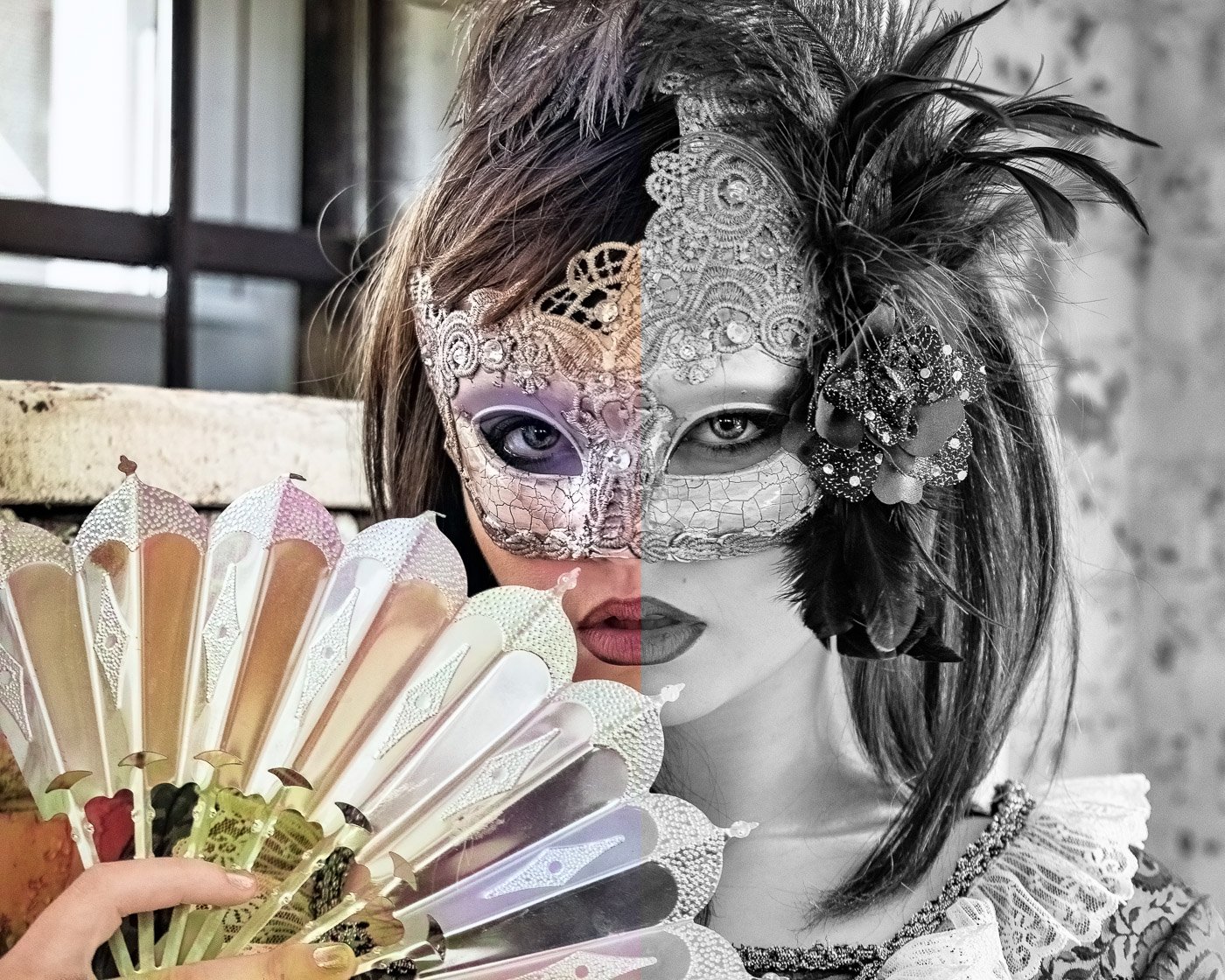 An image of a woman in a masquerade mask and holding a fan with one side color and the other side black and white
