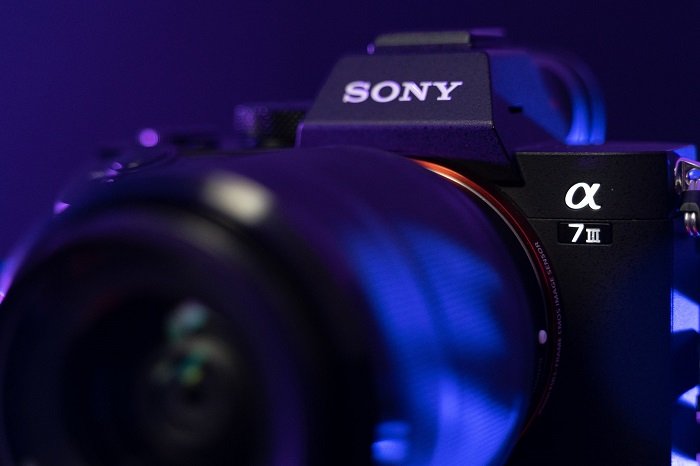 a close up shot of the Sony A7 III with blue lighting effects 