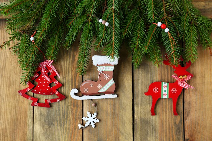 Christmas flat lay of vintage tree skate and reindeer decorations on a wood panel floor