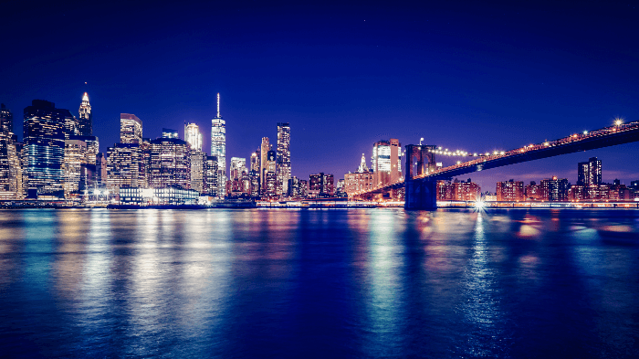 cityscape photography: A long exposure shot of New York City at night shot from Brooklyn Bridge Park