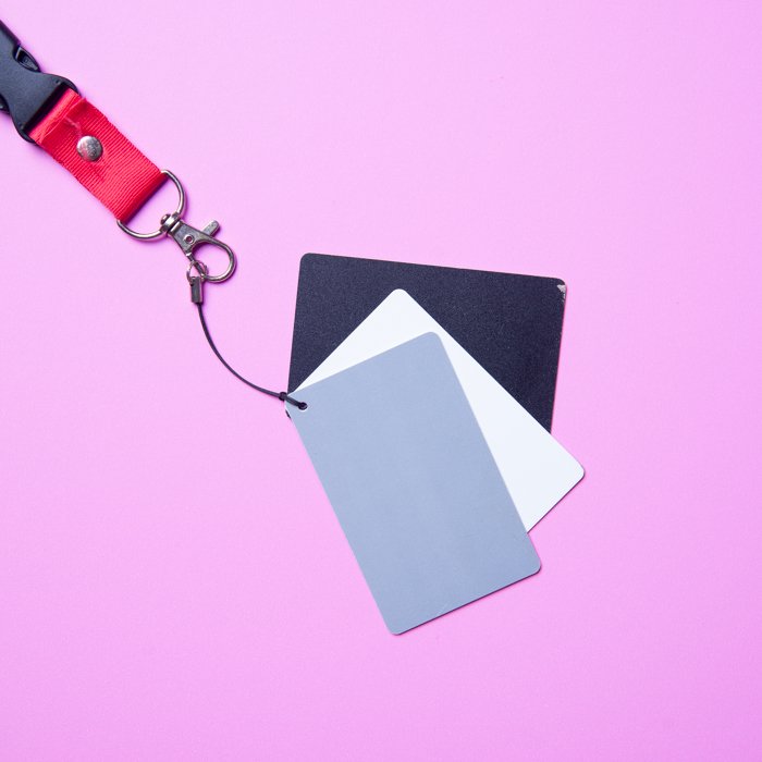 A flat lay photo of grey white and black cards used for determining white balance