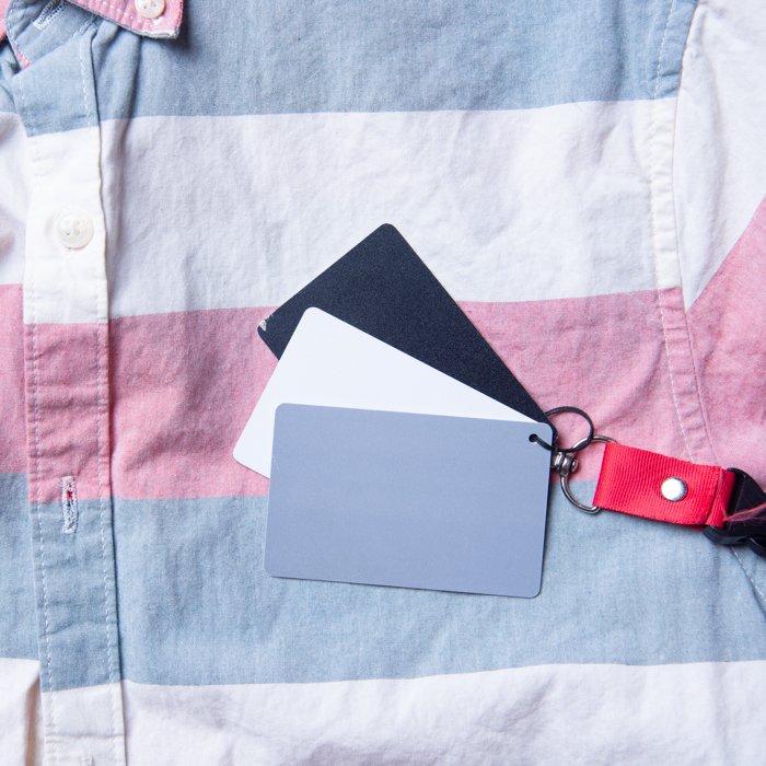 Tips for Flat Lay Photography of Clothing: Grey white and black card placed on a shirt to set white balance in photo editing software