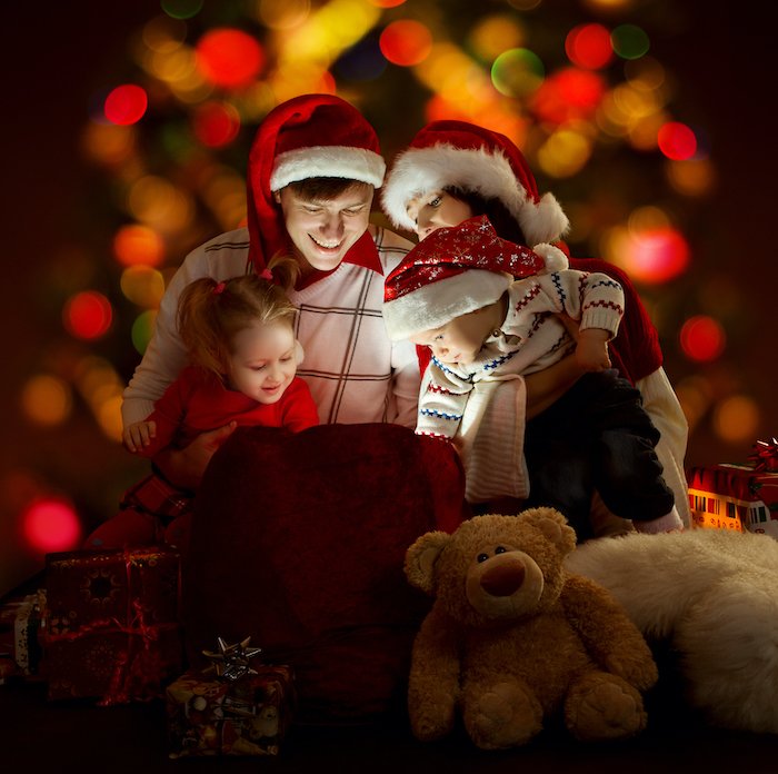 Family photo with lights and Santa hats for Christmas card photo ideas