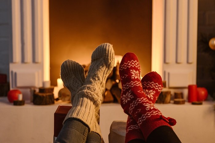 Christmas couple photoshoot idea: a photo of two people feet in cosy winter socks