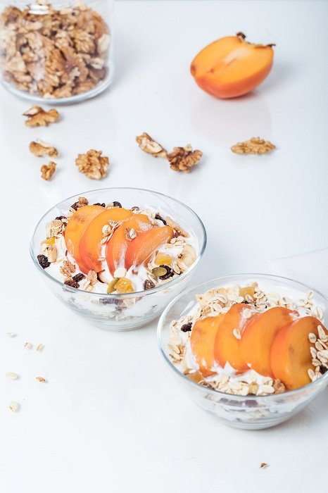 Food Photography tips: two bowls of peach parfait captured on a white table