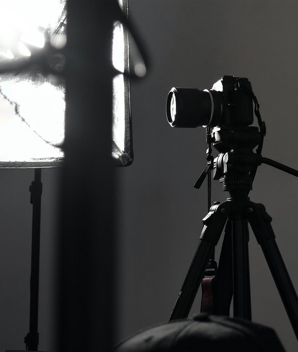 Camera on a tripod in a studio setting with big light